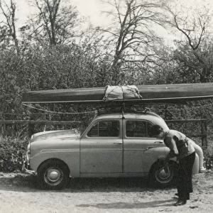 Kayak on the roof of a small 1950s UK car