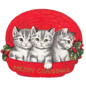 Three kittens in a basket on a cutout Christmas card Three kittens in a basket on a cutout Christmas card