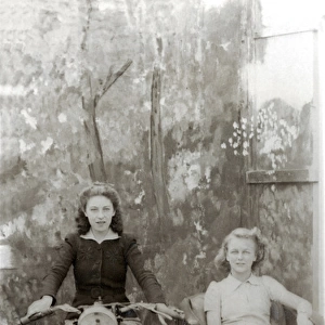 Two ladies in studio on a 1931 / 2 Raleigh motorcycle