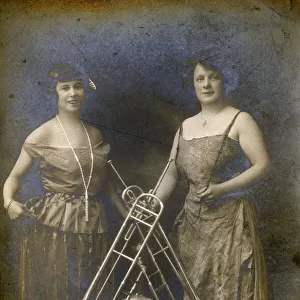 Two Lady Brass Musicians and a variety of their instruments