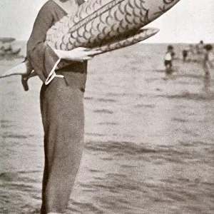 Lady Diana Cooper at Venice Lido with inflatable fish