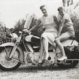 Lady and girl on veteran motorcycle