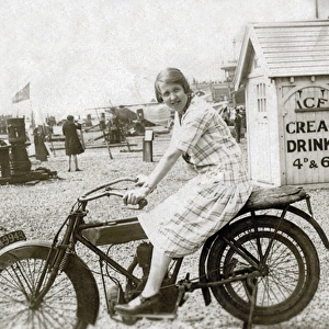 Lady on vintage motorcycle at the seaside