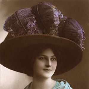 Lady wearing a large hat with Ostrich Feathers