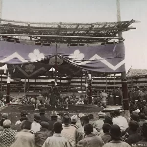 Large crowd watching sumo wrestling outdoor arena