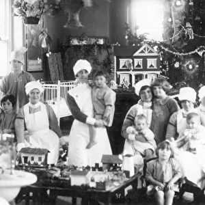 Large informal group of nurses and children, Christmas