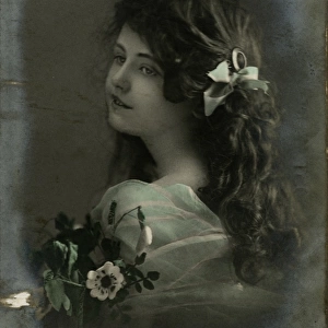 Little girl with dark hair and flowers
