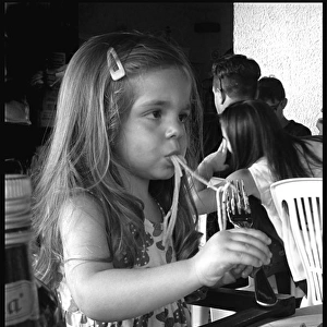 Little girl eating spaghetti, Italy