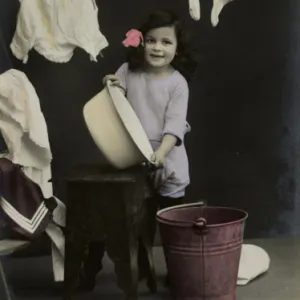 Little girl on a postcard, hanging up the washing