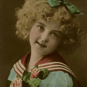 Little girl in sailor suit, with flowers