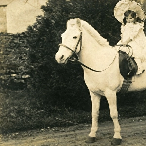 Little girl on white horse