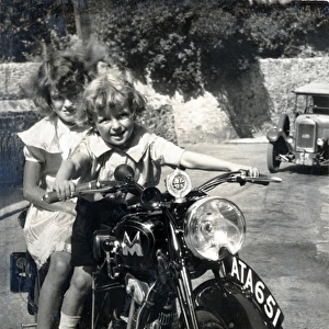 Two little girls sitting on 1934 Matchless motorcycle