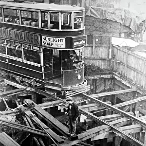 A London tram passing over cut and cover works