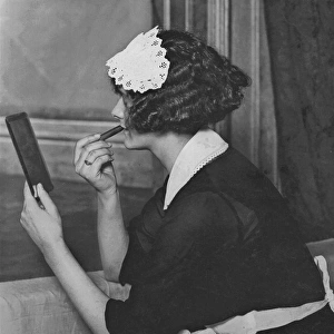 Maid applying lipstick