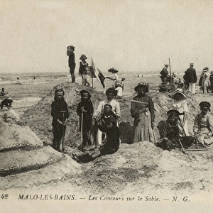 Malo-les-Bains, France - children building sandcastles