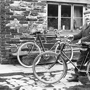 Man with bicycles outside house