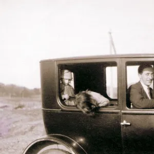 Man and two children in a car