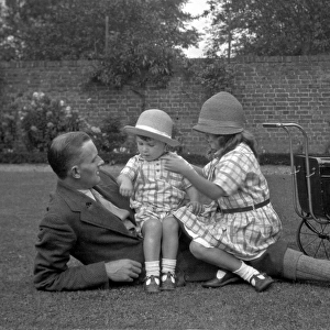 Man with two children and a toy pram