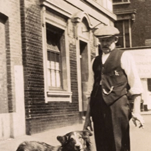 Man with a collie dog in a street