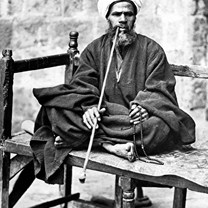 Man with pipe and beads, Egypt