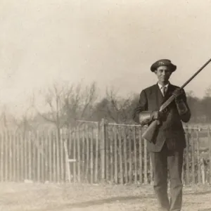 Man posing with rifle