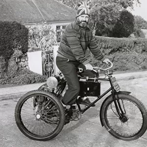 Man riding an 1899 Marot-Gardon vintage tricycle