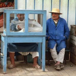 Man sits beside a small food stall in Houmt Souk, Djerba Man sits beside a small food stall in Houmt Souk, Djerba