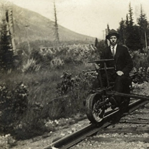 A man sitting on part of a modified railway suspension