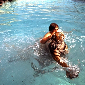 Man swimming with tiger