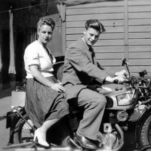 Man & woman on a 1939 Norton motorcycle