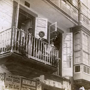 Four men on a balcony in Ferrol, Galicia, Spain