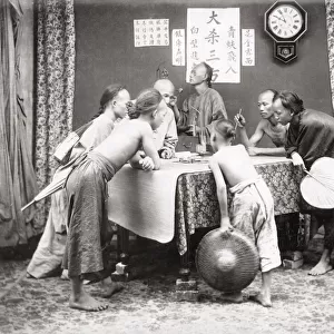 Men and boys with weighing scales, China c. 1890