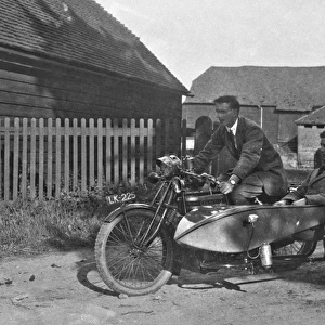 Two men with motorbike and sidecar