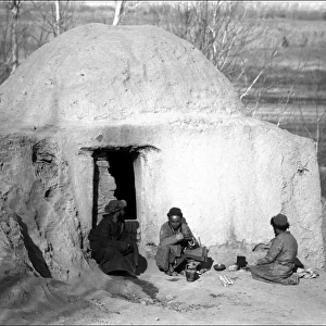 Three men outside a dwelling, Kashgar, western China