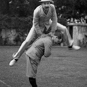 Two men playing leapfrog