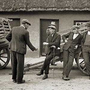 Men resting at the side of a cart