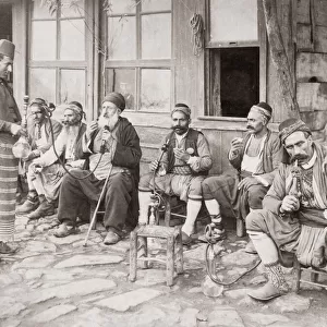 Men smoking hookah pipes outside a Turkish cafe, Turkey. c. 1880 s