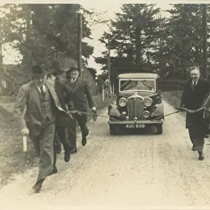 Men Towing Vintage Rover Car