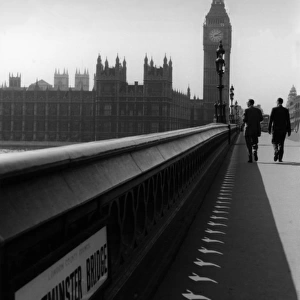 Two men walking over Westminster bridge