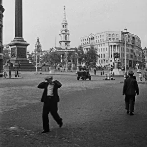 Men on their way to work, Trafalgar Square, London