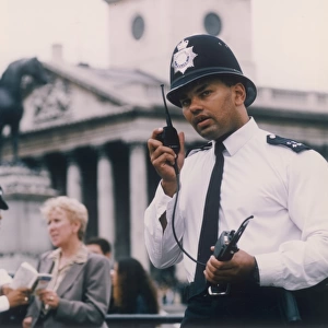 Met Police officer on his radio, London