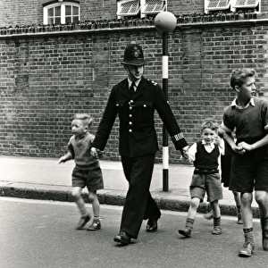 Metropolitan Police officer and children crossing road