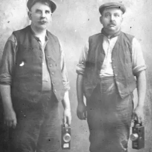 Two middle aged miners with their lamps, South Wales