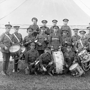 Military band with instruments in front of a tent