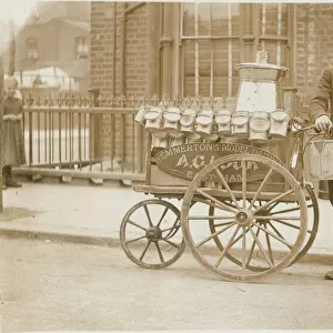 Milk boy with three-wheeled cart & cans