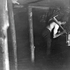 Miner working in a coal seam, South Wales