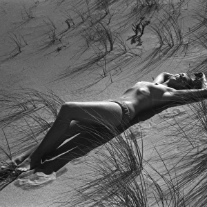 Model reclining in the sand dunes