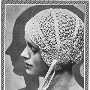 Model wearing close-fitting crocheted bourdoir cap Date: 1929