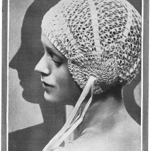 Model wearing close-fitting crocheted bourdoir cap Date: 1929 Model wearing close-fitting crocheted bourdoir cap Date: 1929
