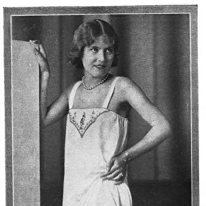 Model wearing embroidered chemise over embroidered long knickers and stockings Date: 1920s